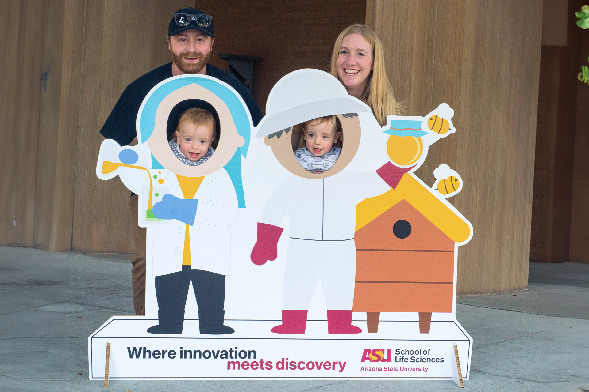 Photo of family in behind the cutout of 3D cutout of the scientist and beekeeper.