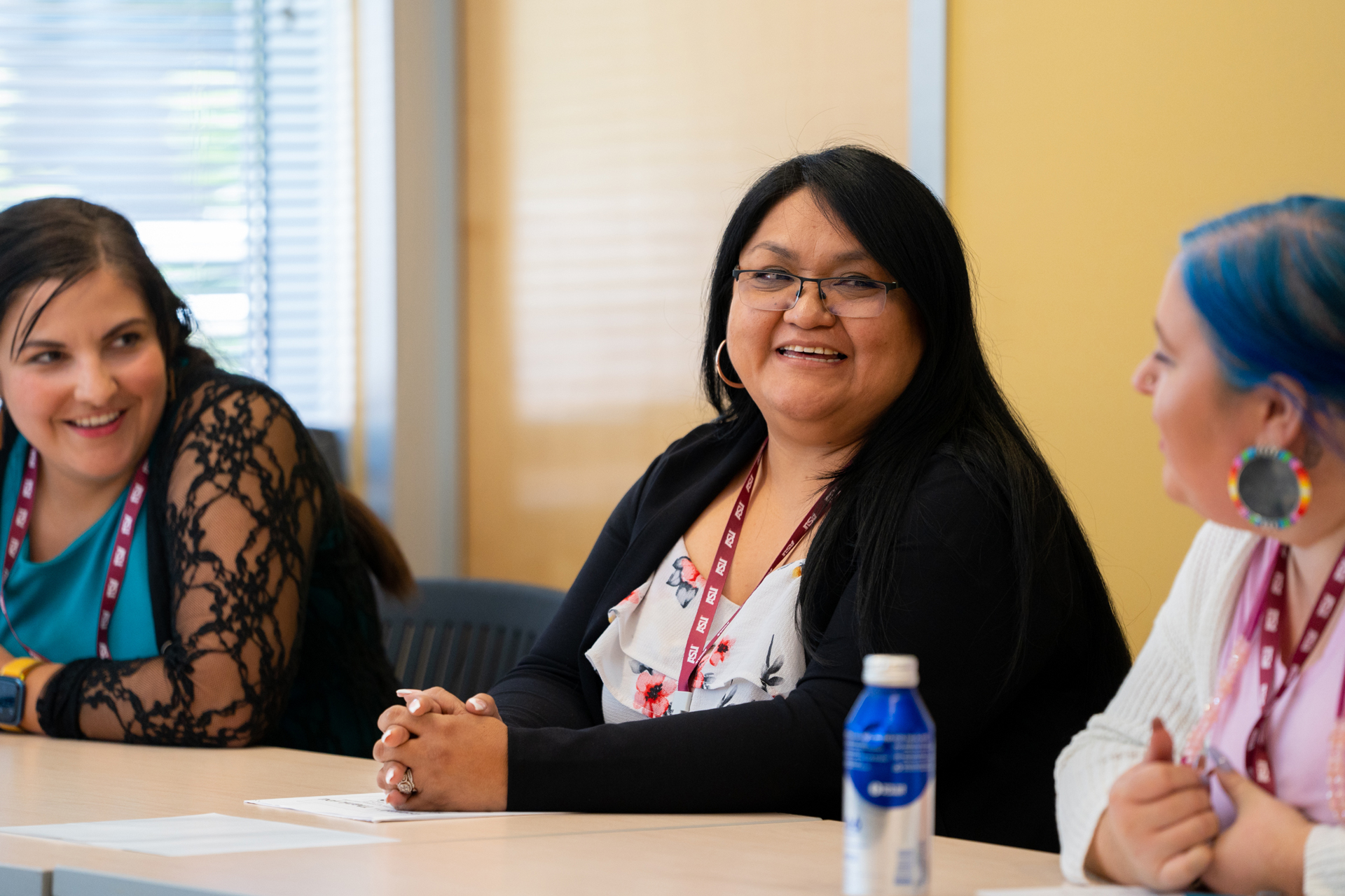 Three female conference attendees seated at a table